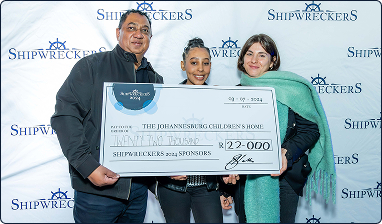 Mr Siva holding the cheque with the beneficiaries